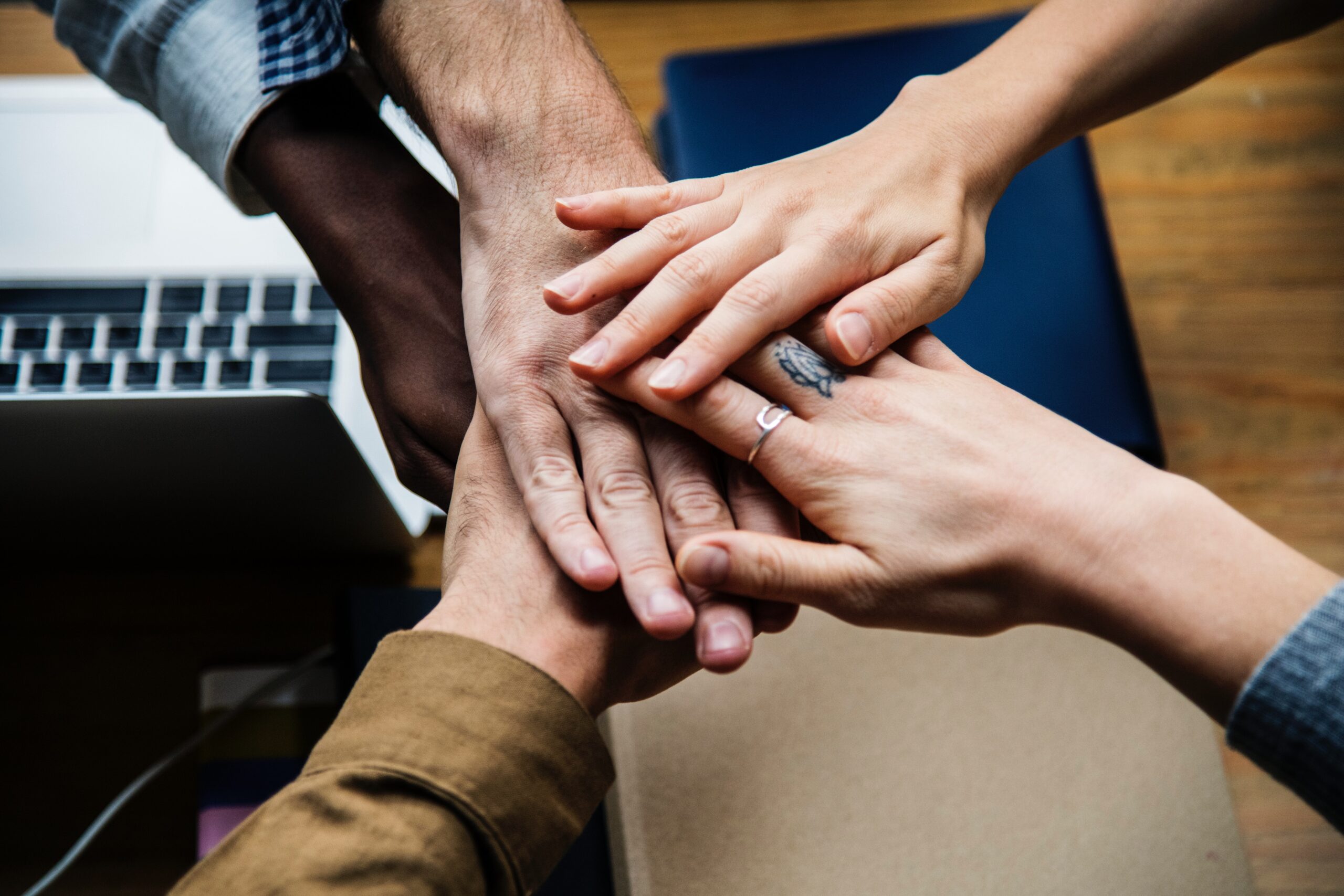 people's hands overlapping on centre rawpixel-683571-unsplash